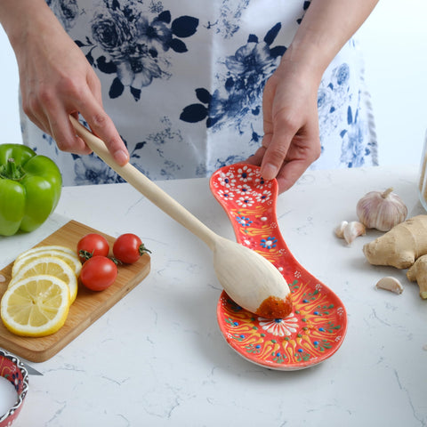 EVANILIFE orange spoon rest on kitchen counter with spatula.