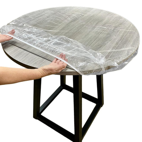 Evelots clear round table cover on table protects surface while preserving finish.