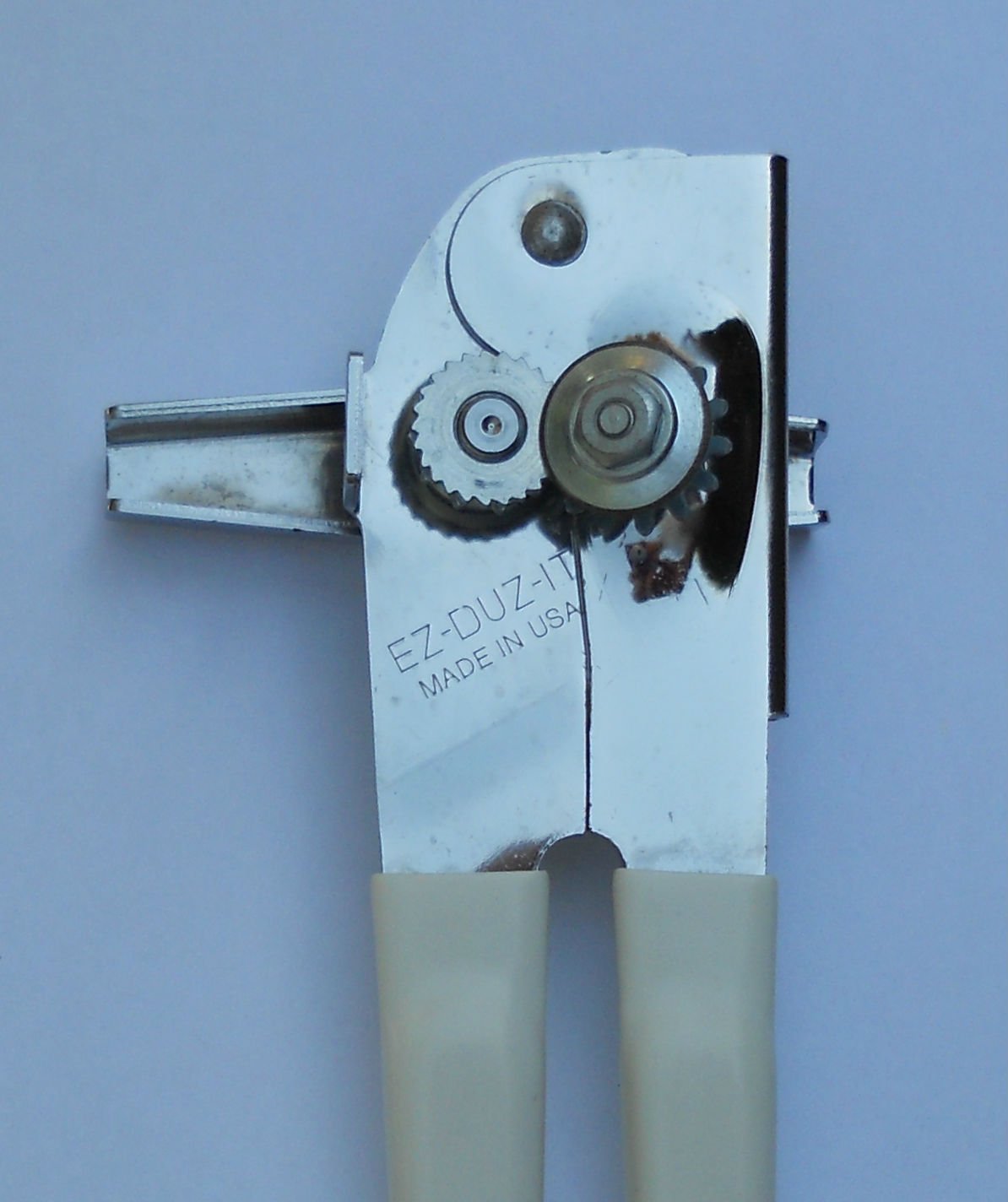 EZ-DUZ-IT white can opener close-up on cutting blade highlighting durability.