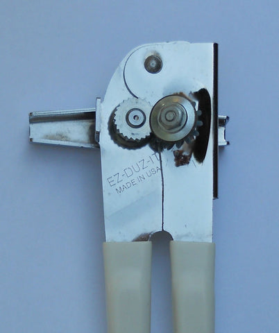 EZ-DUZ-IT white can opener close-up on cutting blade highlighting durability.