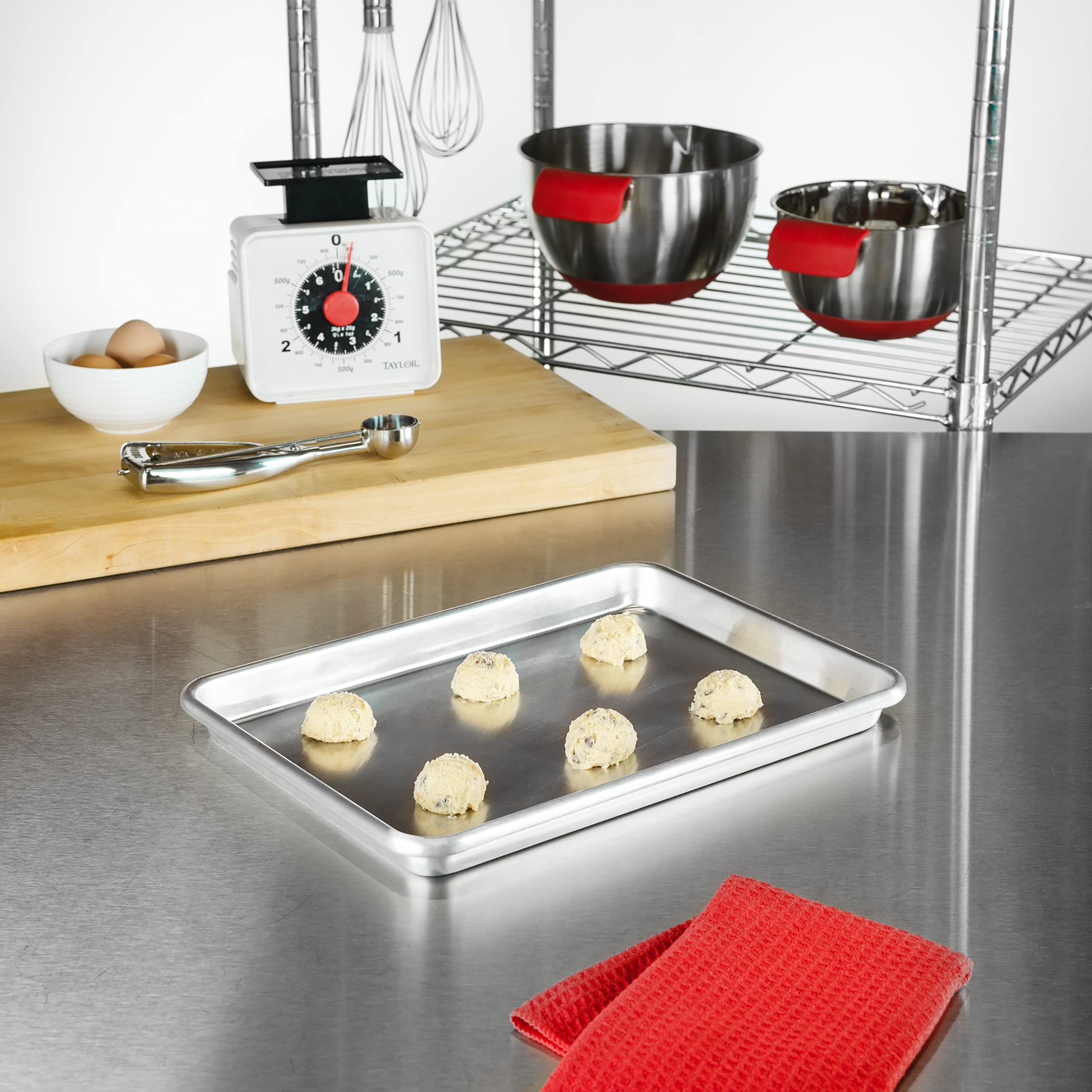 Cookies baking on Fat Daddio's SP-QTR quarter sheet pan highlight versatile pastry use.