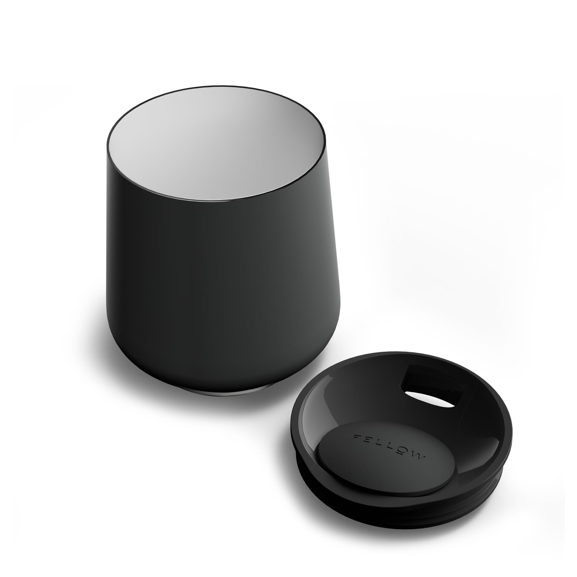 Fellow Ruby tumbler with swivel pebble lid prevents splashes while sipping.