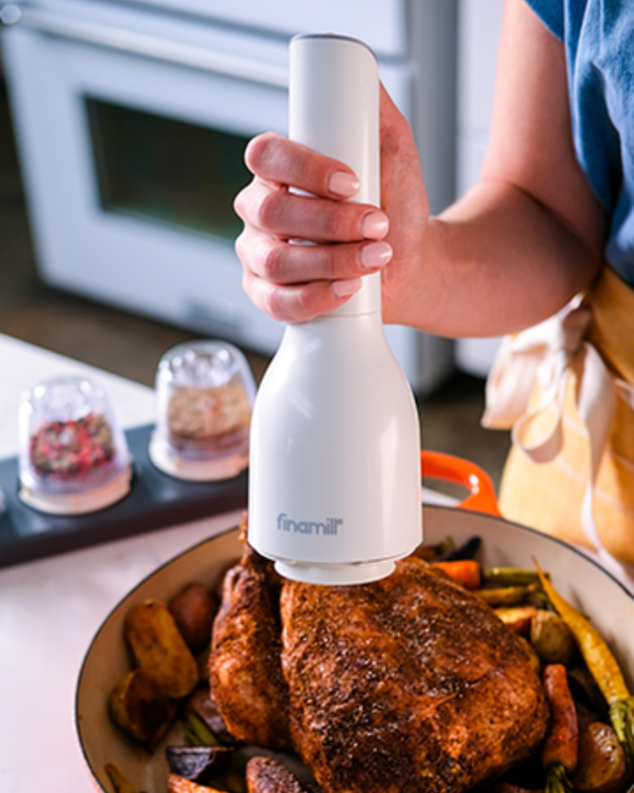 FinaMill in action on a kitchen counter illustrating convenient handheld use for multitasking.