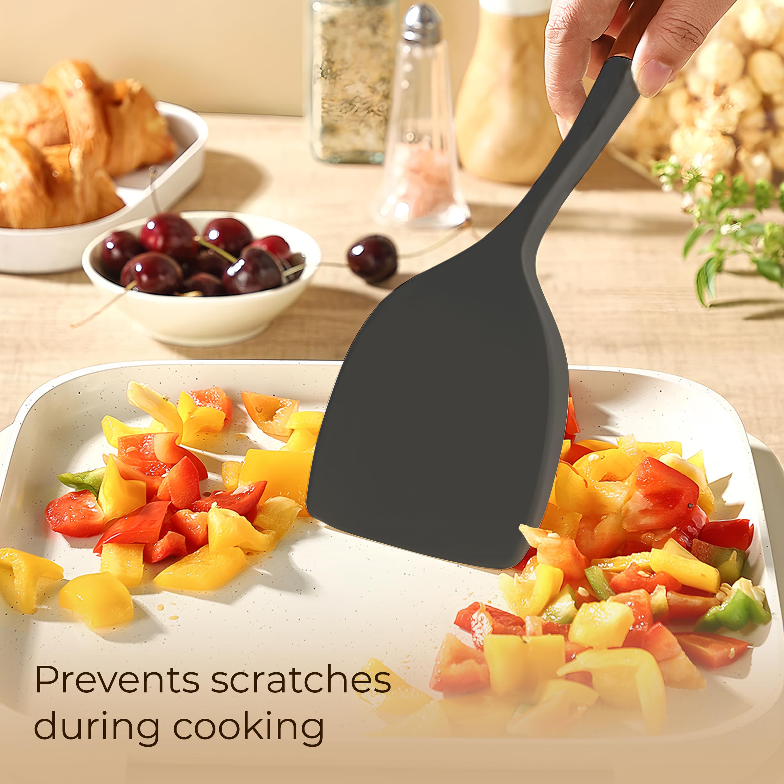 FINENUT heat-resistant silicone utensils handling hot pans safely.