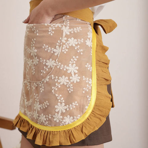 Floosum cotton washed detail apron yellow closeup highlights soft fabric.