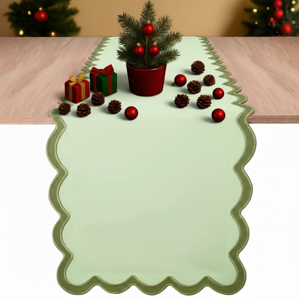 Folkulture table runner in sage green with scalloped edges for elegant dining.