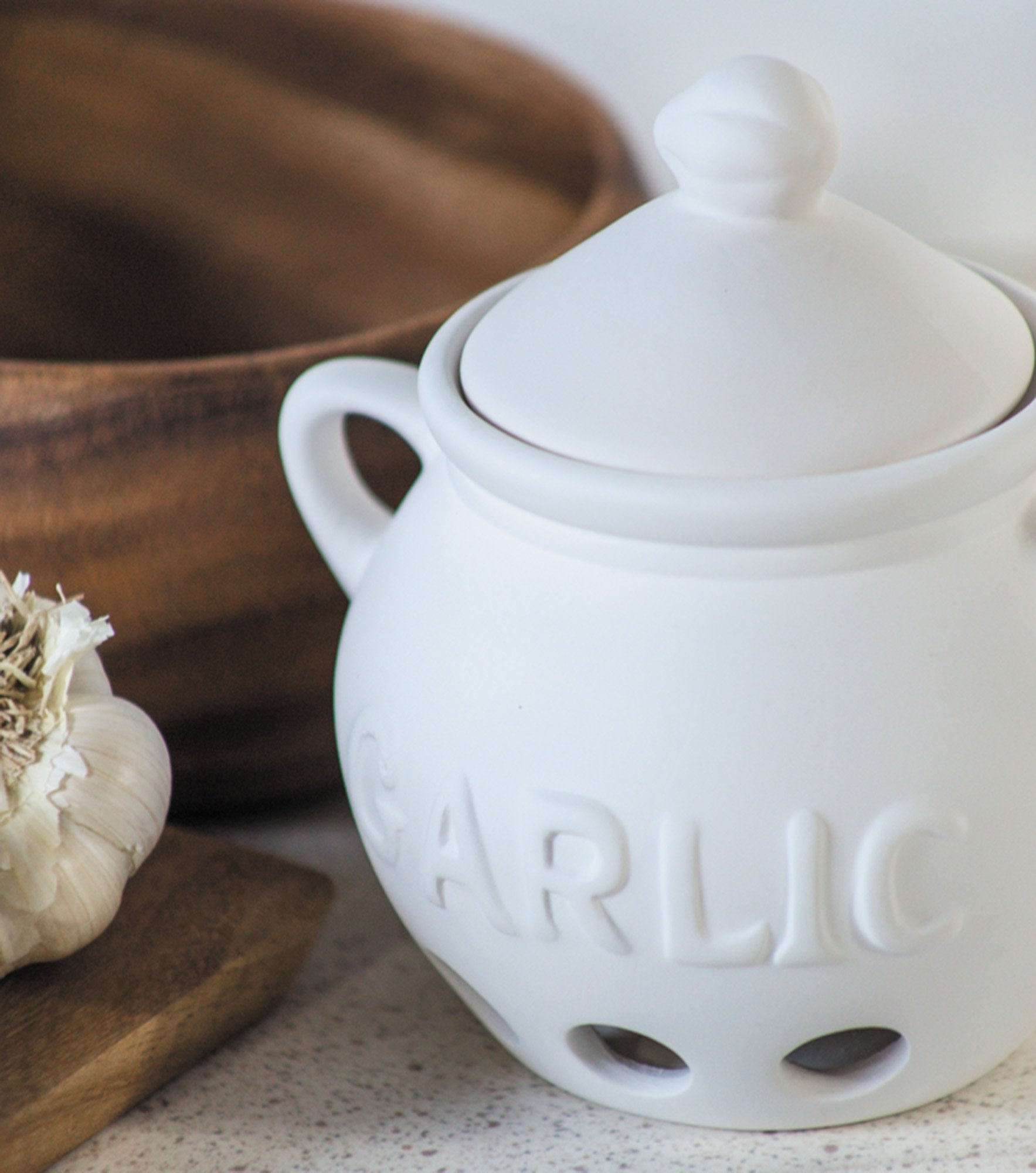 Fox Run garlic keeper features vent holes promoting airflow for cool, dry storage.