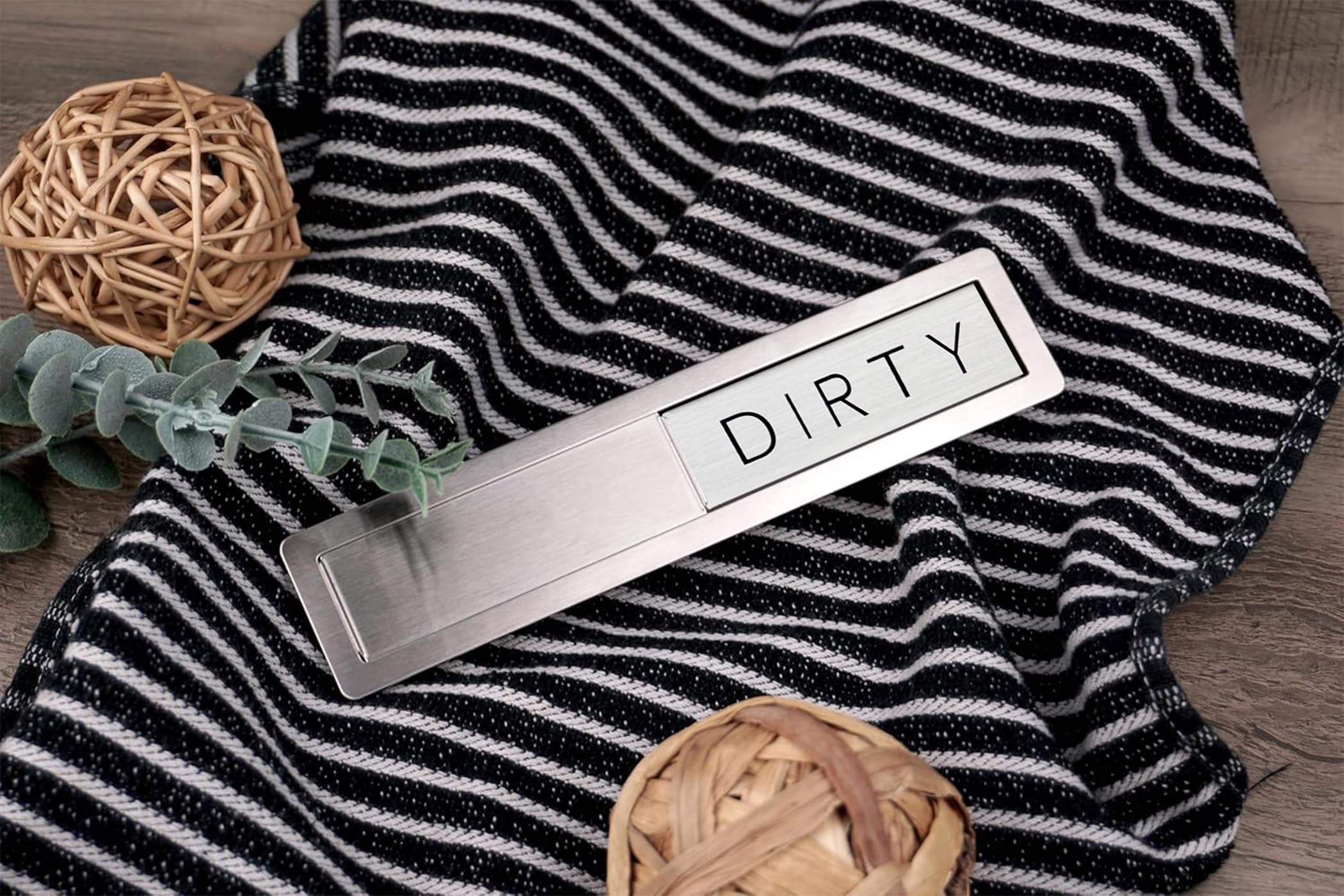 Close-up of FridayVibez magnet on stainless steel for durable use.