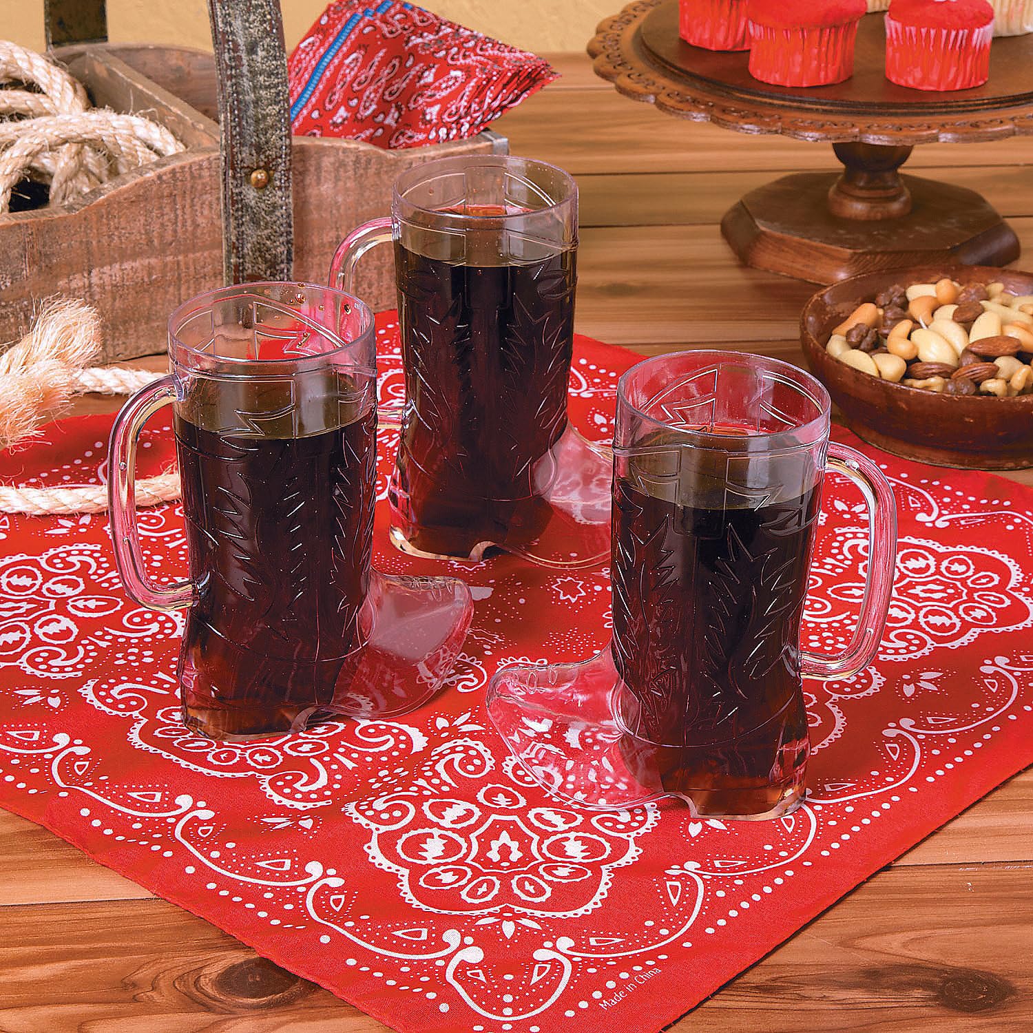 Clear 17oz boot mugs arranged for drinks at a rodeo-themed gathering.