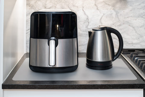 Gasare two-pack silicone mats shield countertops from spills and hot pots.