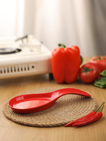Glossy red GDCZ porcelain rest holds tongs and spatulas neatly.