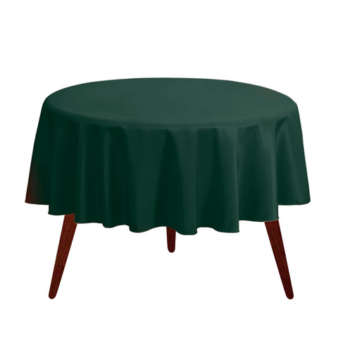 Gee Di Moda round tablecloth on a hunter green table setup for a formal dining scene