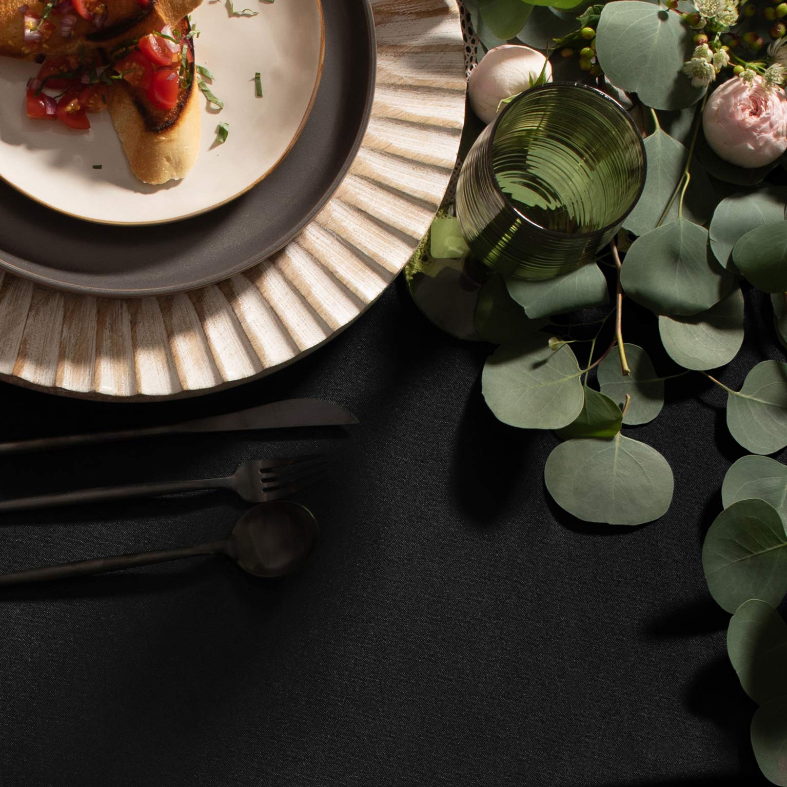 Gee Di Moda tablecloth with hemmed edges enhances formal dining presentation.
