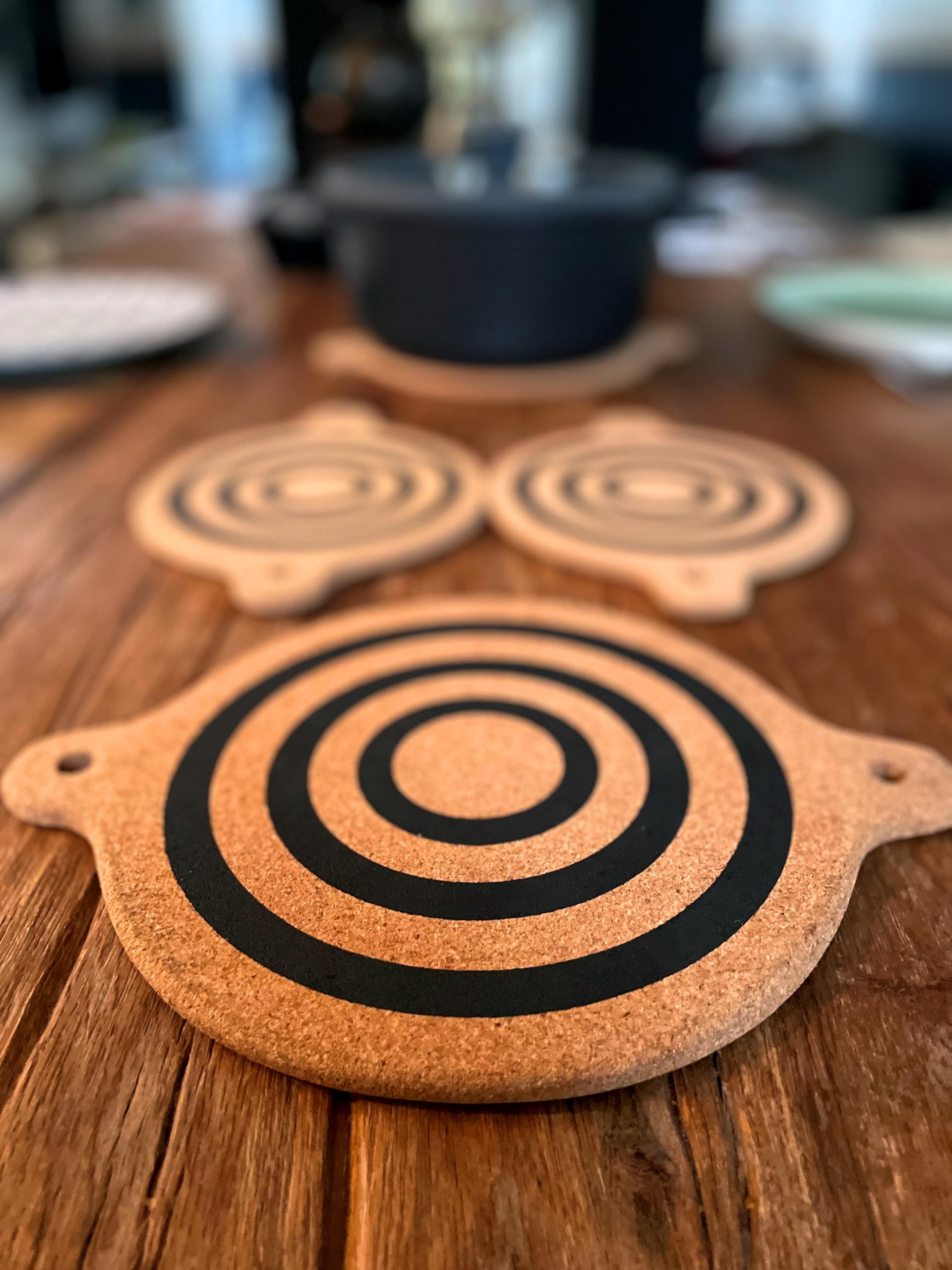 Generic magnet cork-trivet beside cookware in a busy kitchen