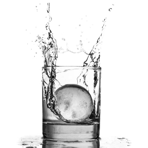 Glacio round ice ball mold supports popsicles and frozen drinks.