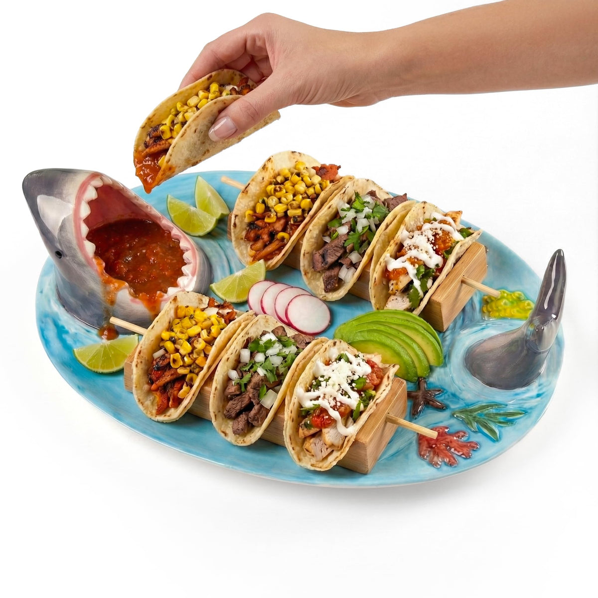 Glazery blue ceramic taco holder with built-in sauce dish for dipping.