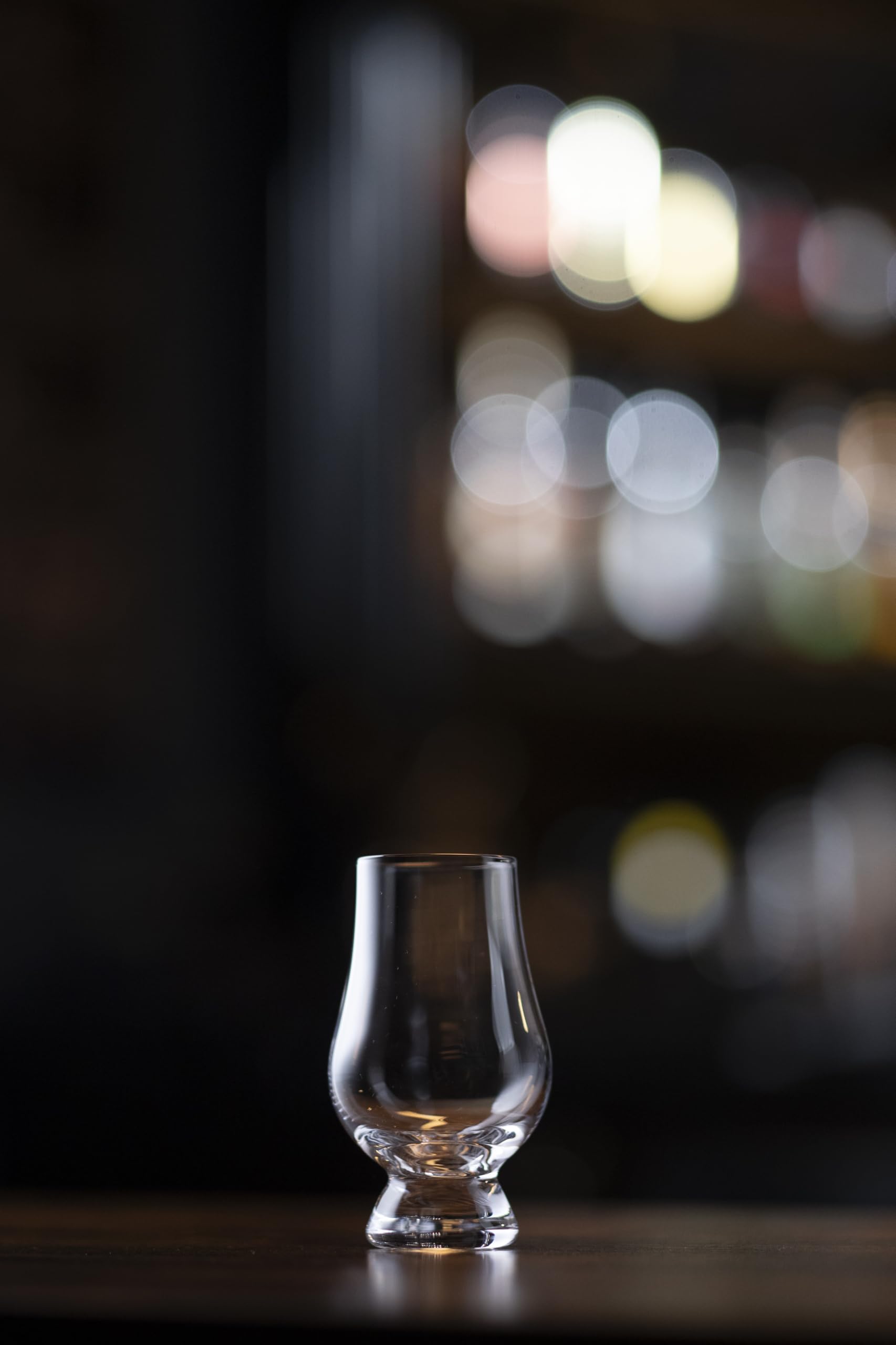 Hand holding Glencairn Wee glass to savor a small dram.