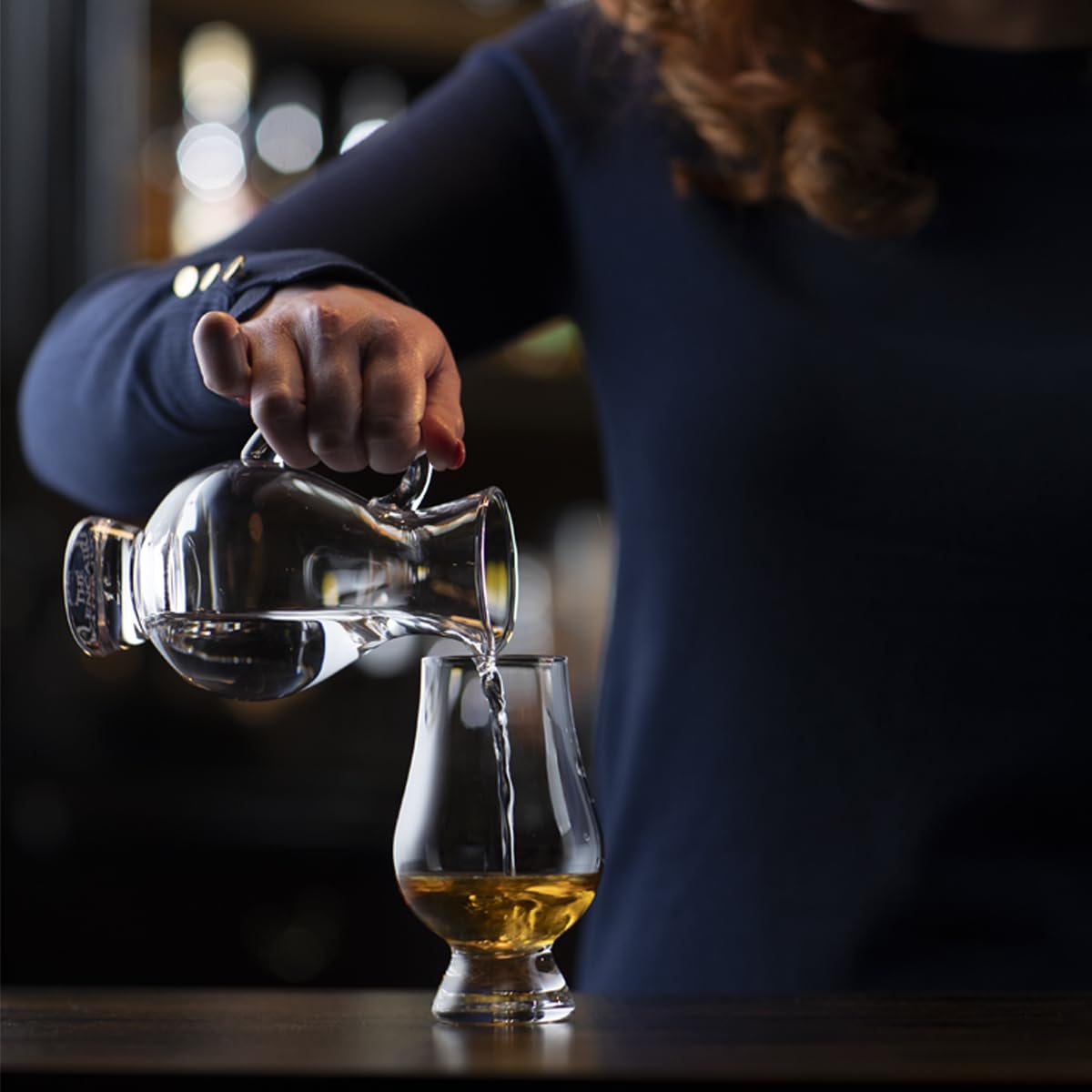 Glencairn whiskey glass held in hand to illustrate comfortable grip.