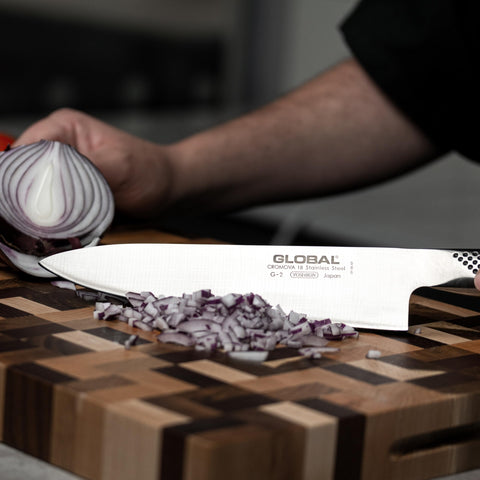 Global 8-inch chef knife dimpled stainless-steel handle for secure grip.