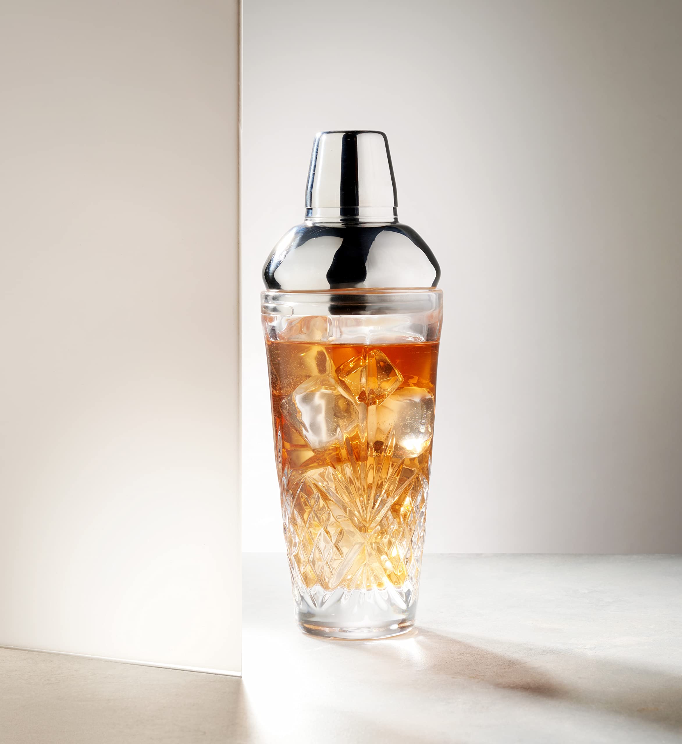 Godinger Dublin crystal martini shaker in use with two cocktails
