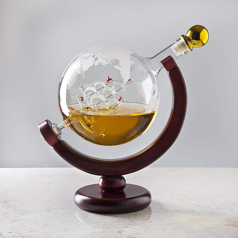 Godinger decanter on mahogany stand with gold stopper for refined display.