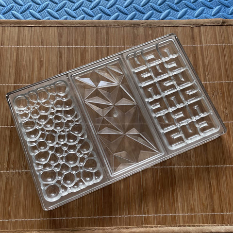 Goldbaking finished chocolate bars on plate with professional shine.