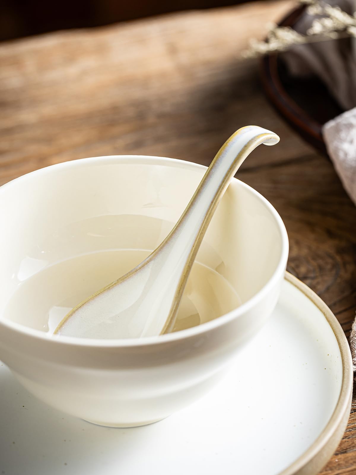Gomakren spoon with dumplings and miso broth ready for serving.