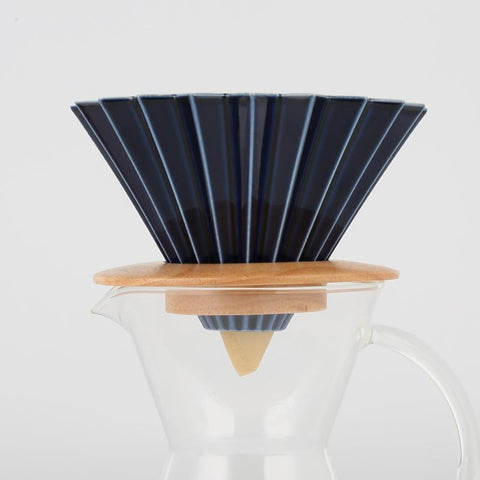Goodening coffee dripper with cup-fit design on a mug.