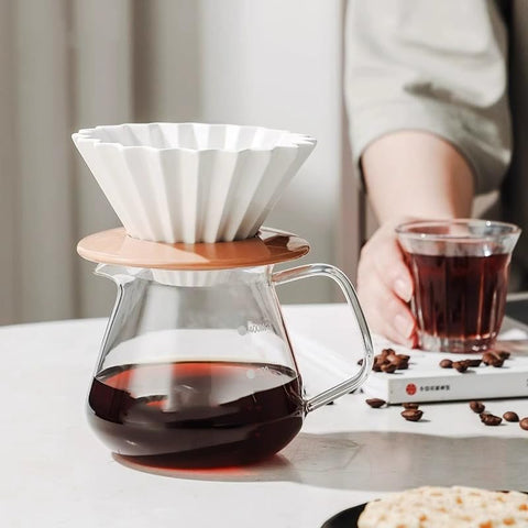 Goodening elegant dripper paired with wooden stand on a kitchen counter.