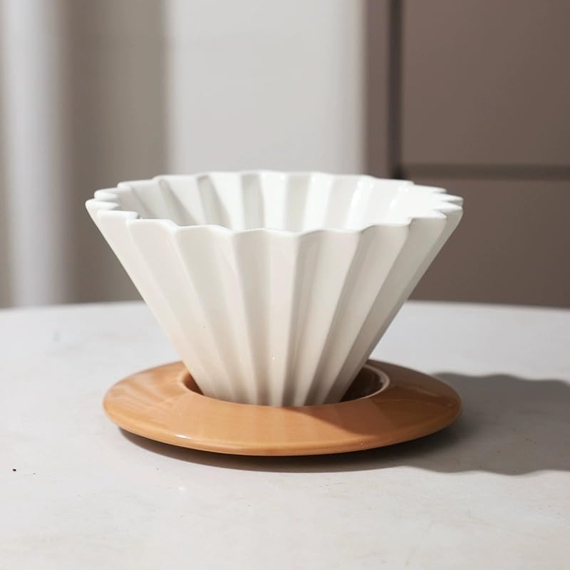 Close-up of Goodening floral-shaped dripper design on porcelain.