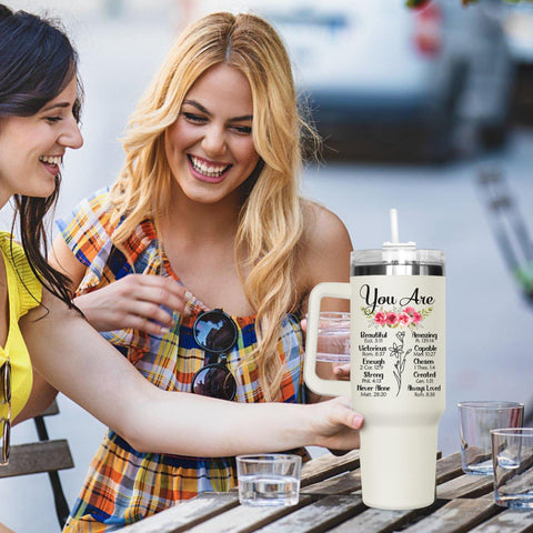 Lifestyle scene of a woman drinking from GOOLERY 40oz tumbler