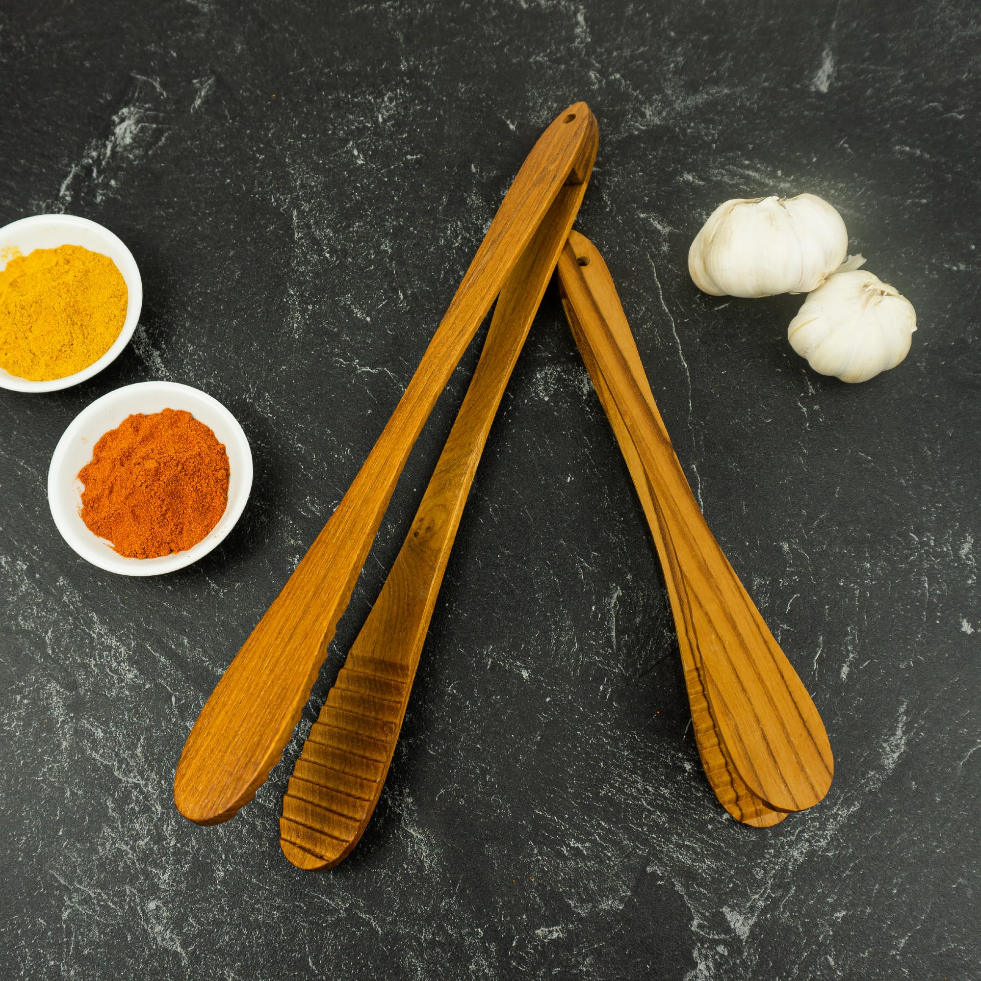 Graindi teak tongs designed in Bali for functional elegance and grain detail.