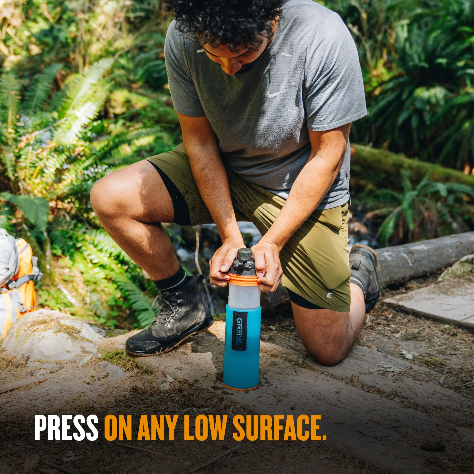 GRAYL GeoPress filtering water into a cup during camping for safe drinking