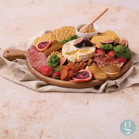 Grazerie serving board setup ideal for cheese, fruits, and crackers.