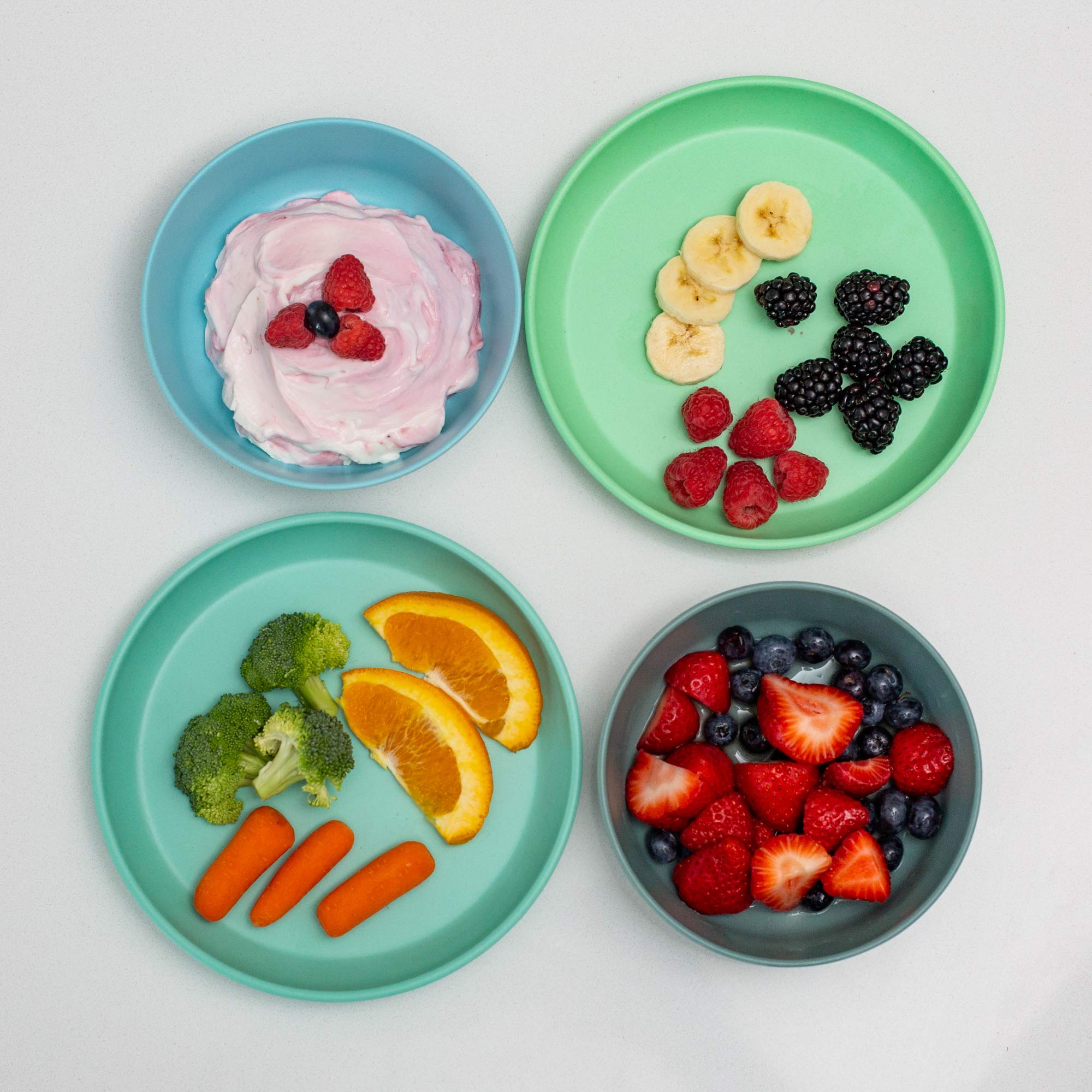 Grow Forward rainforest plates with high lip aid self-feeding and reducing spills.
