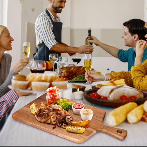 Gtencemen charcuterie and bread board serving setup for cheese, crackers, and fruit.
