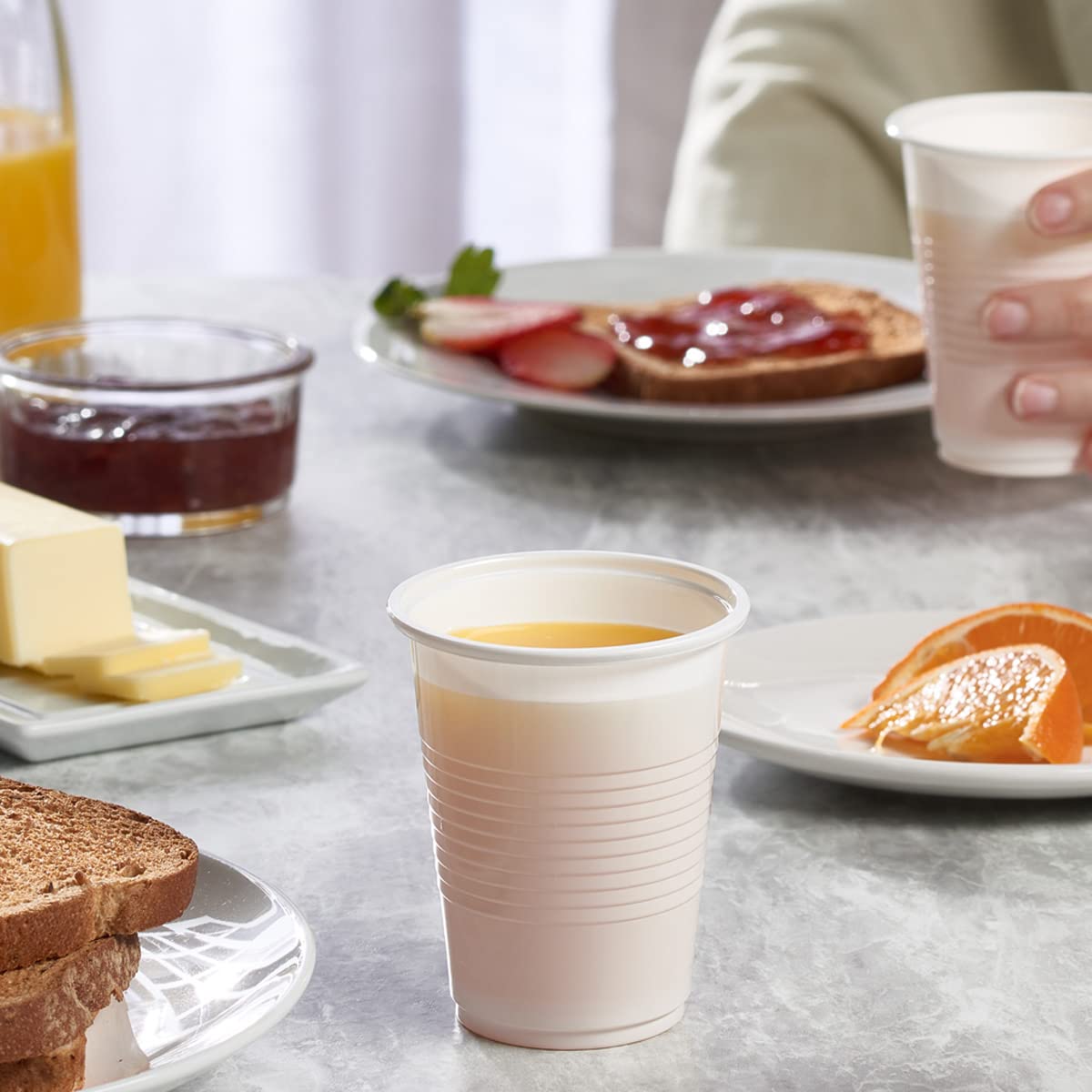 GUSTO Comfy 7oz white cups stacked neatly for quick restocking.