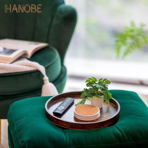 Hanobe tray with candle holder and plant sets a warm, inviting tablescape.