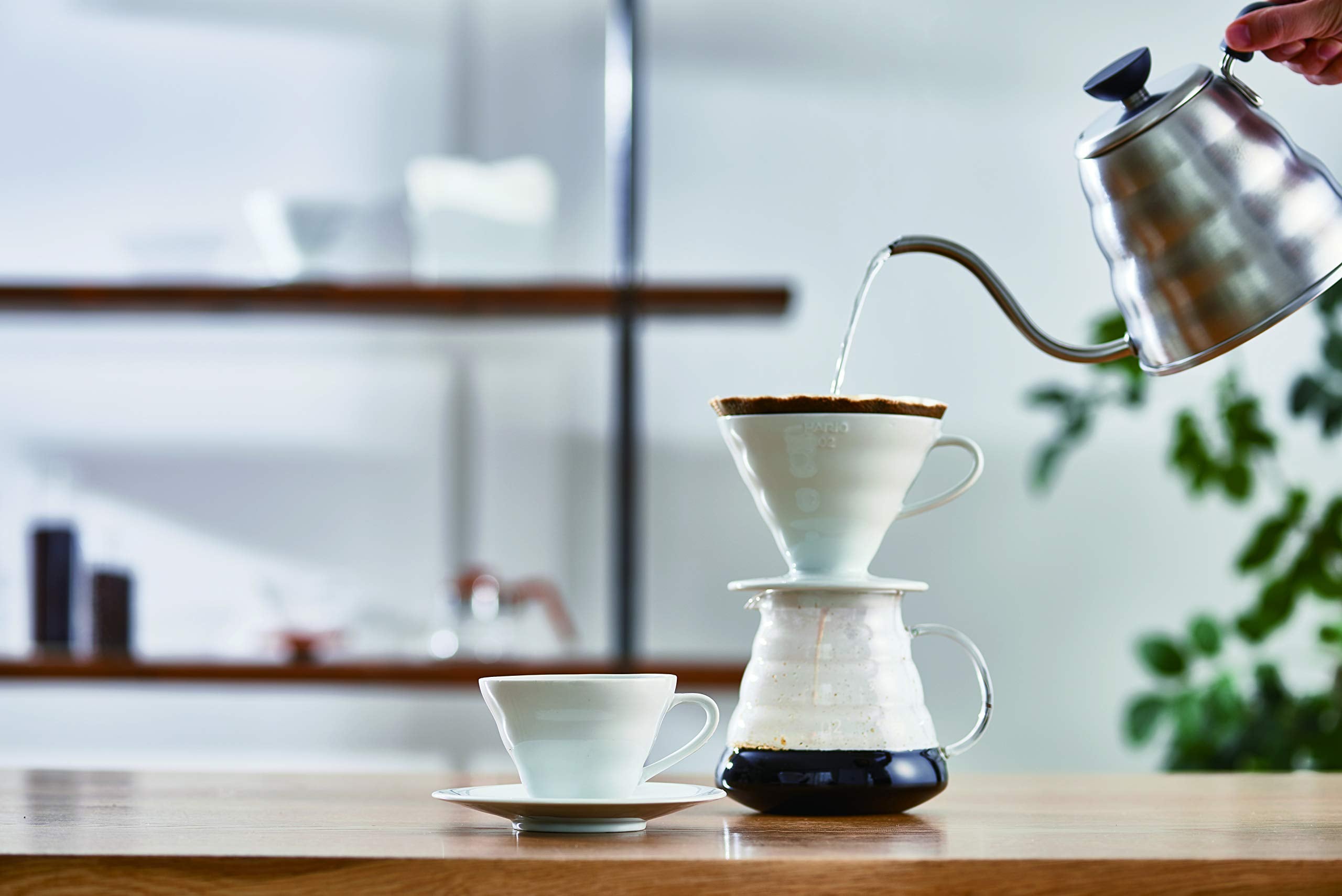 Hario V60 ceramic dripper with single hole pour for precise brewing control.