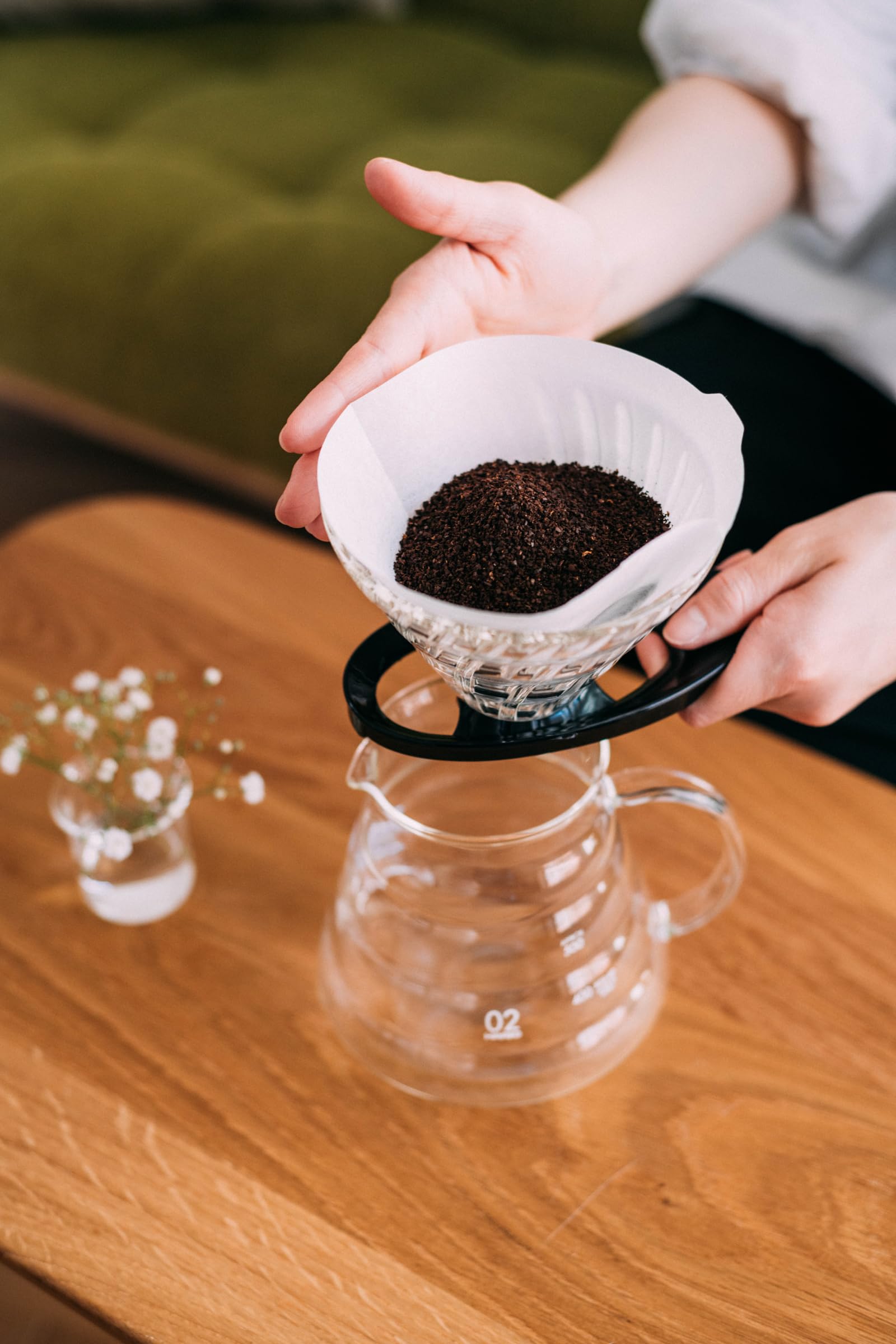 Hario V60 dripper in black shown in a kitchen for quick, consistent pours.
