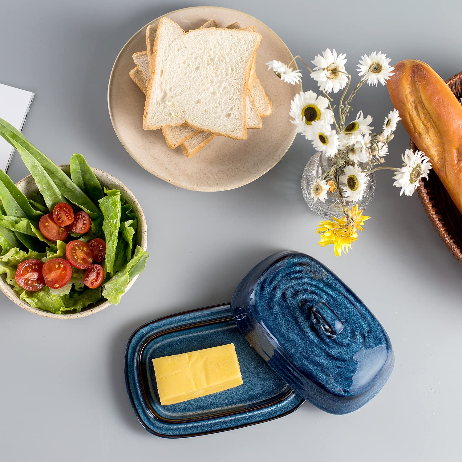 Hasense butter dish shows dimensions 7.3 by 4.9 by 2.9 inches.