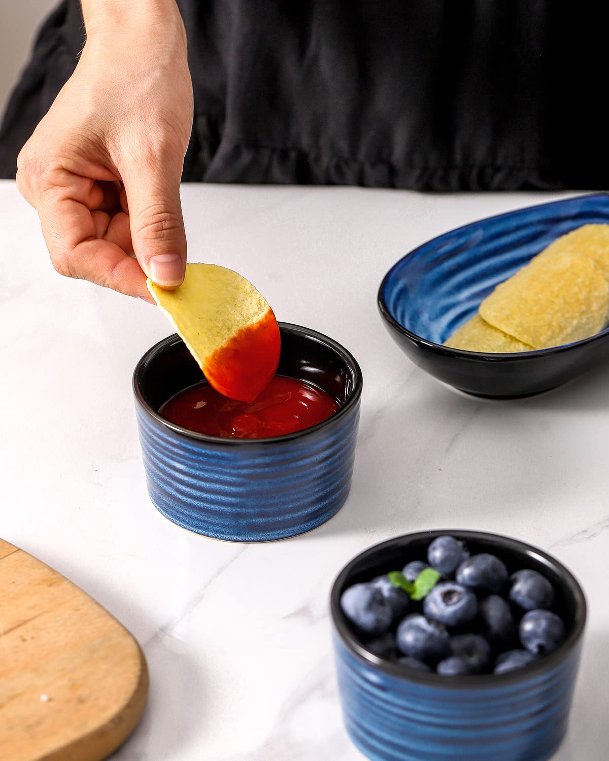 Hasense navy ramekins blend with dinnerware for stylish serving.