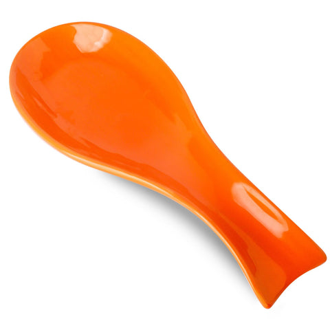 Hasense orange porcelain spoon rest on stove top catching drips during cooking.