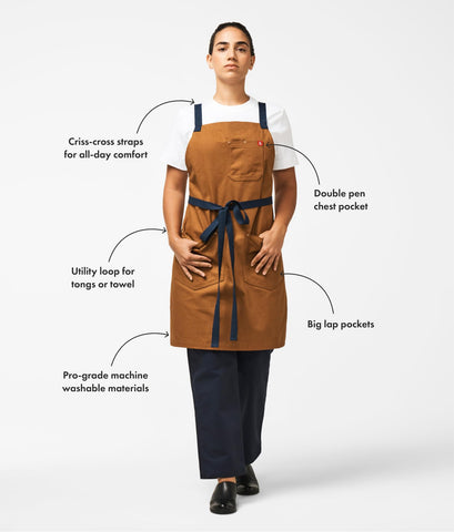 Hedley Bennett Crossback Apron pockets highlight easy tool access while cooking.