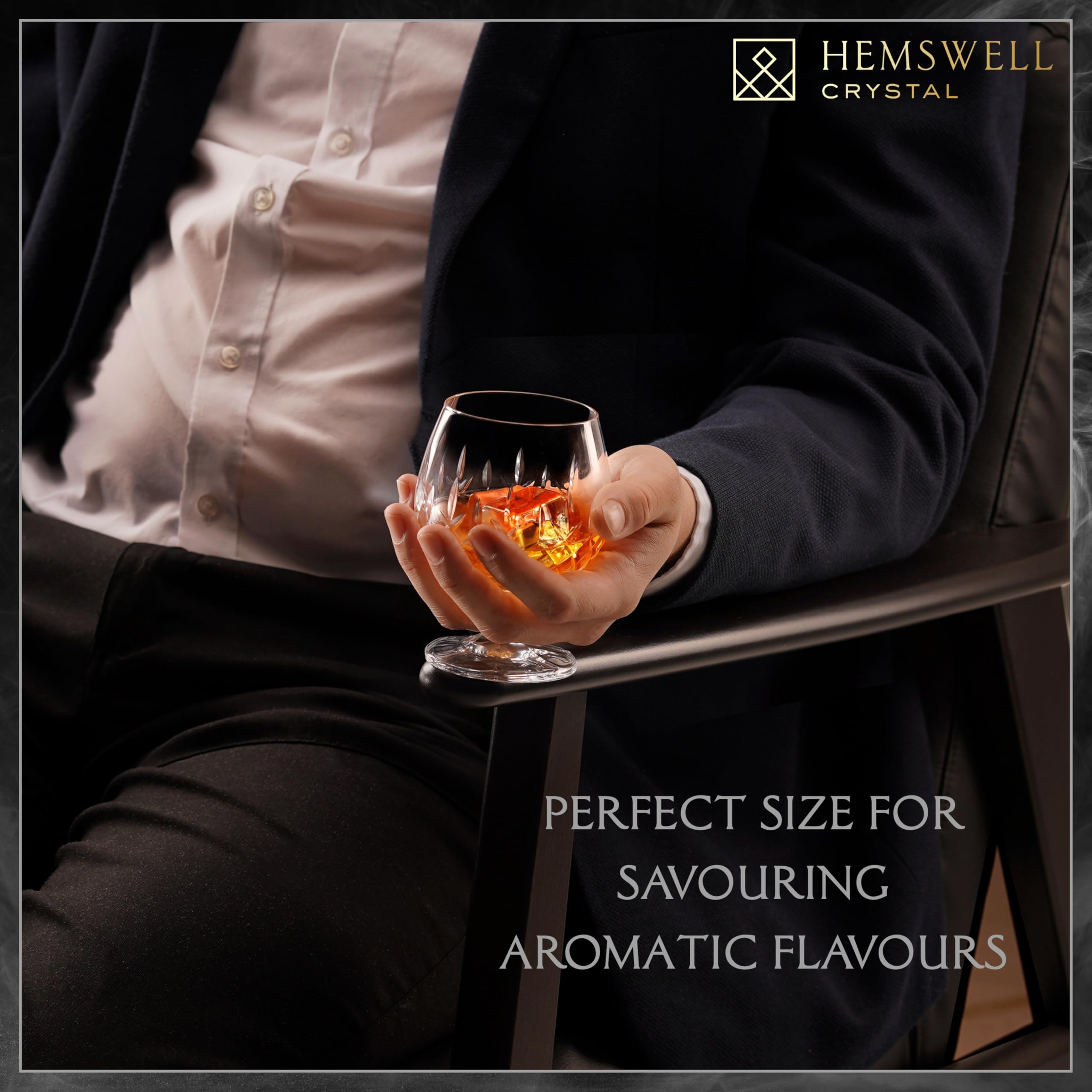 Hemswell Crystal stemmed snifter cradled between fingers, elegance for refined gatherings