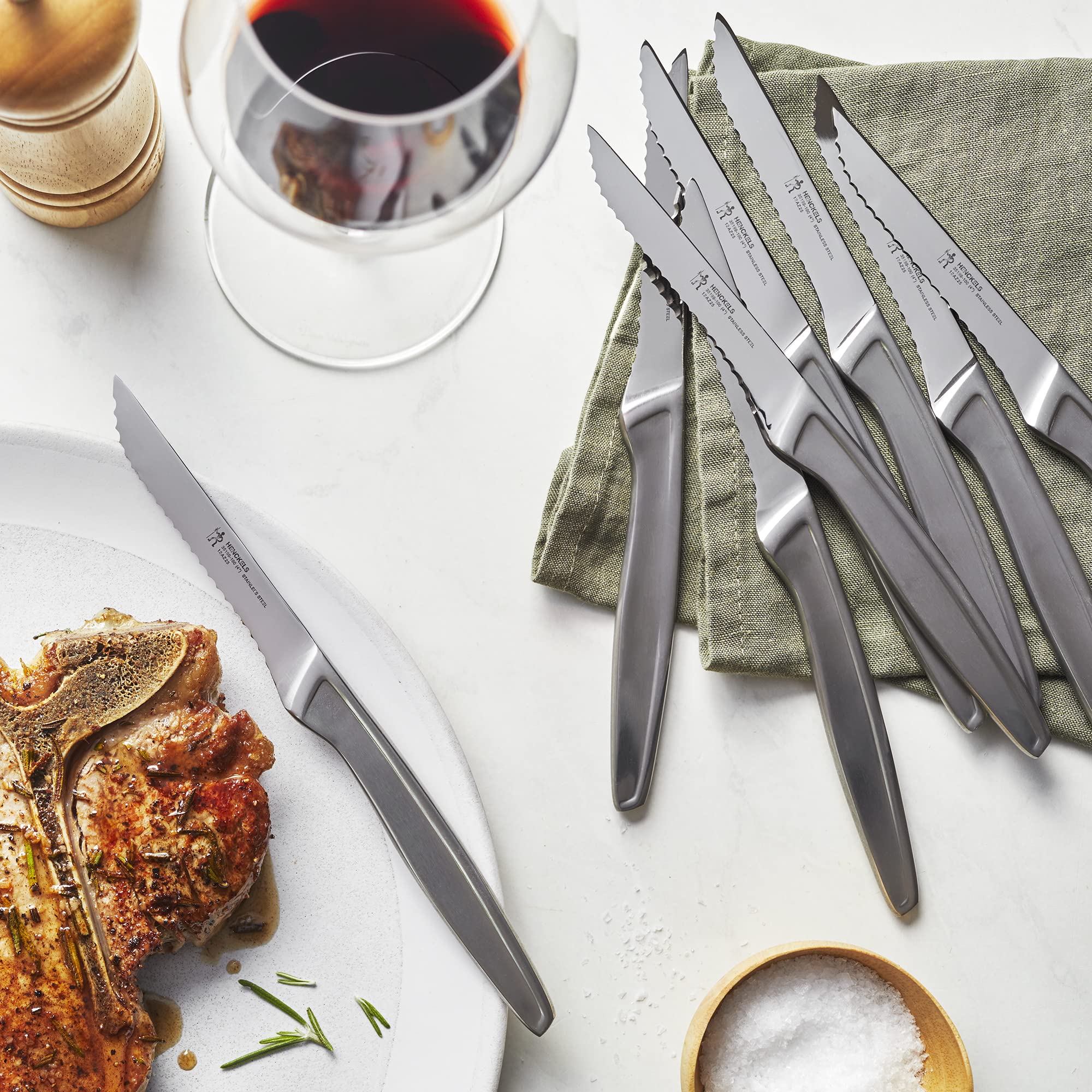 Henckels 8-piece steak knife set on display for a coordinated table setting.