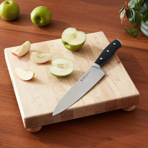 Henckels Forged Accent 8-inch knife forged bolster shows durability and balanced cutting.