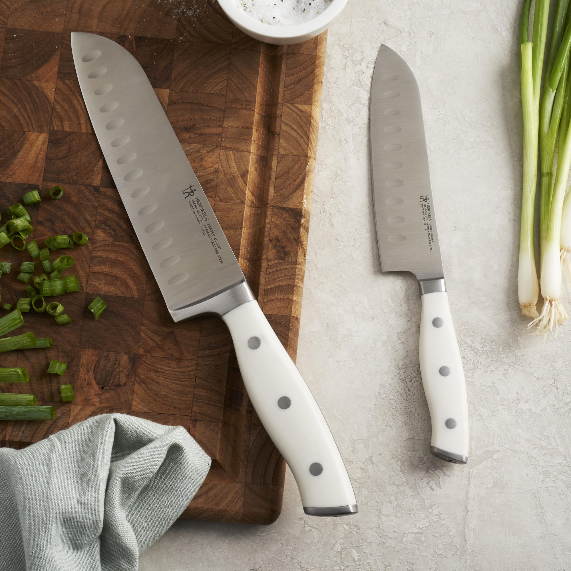 Curved handle with endcap on HENCKELS Forged Accent for comfortable grip.