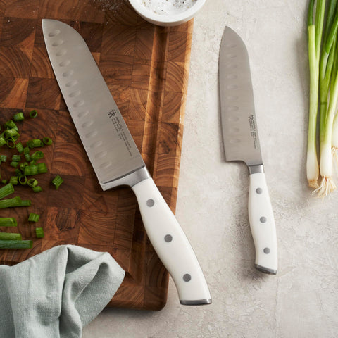 Curved handle with endcap on HENCKELS Forged Accent for comfortable grip.