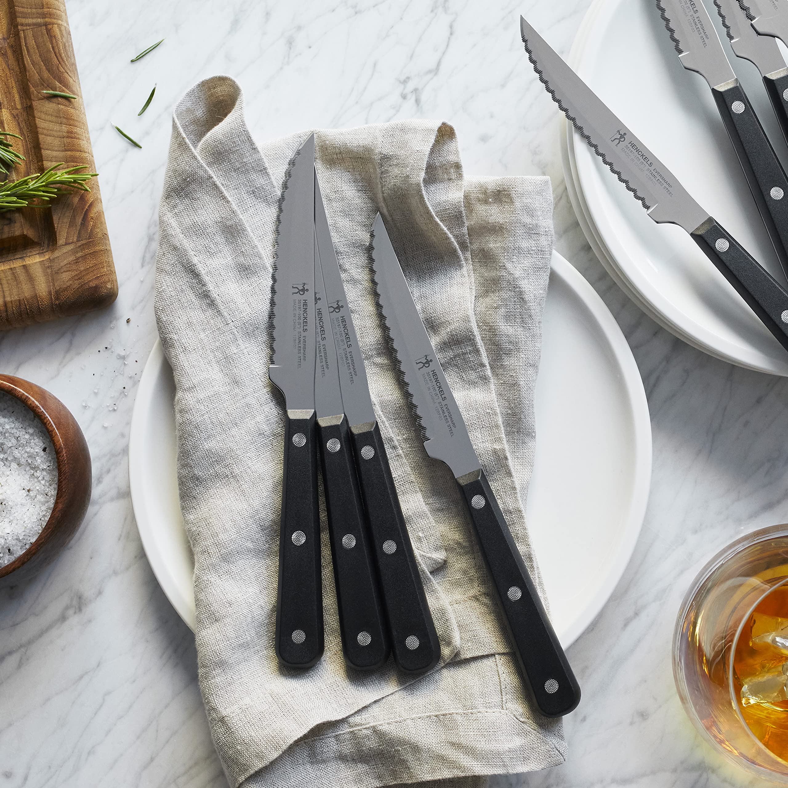 Eight-piece knife set displayed on kitchen counter for entertaining.